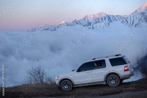 white SUV on the background of mountains