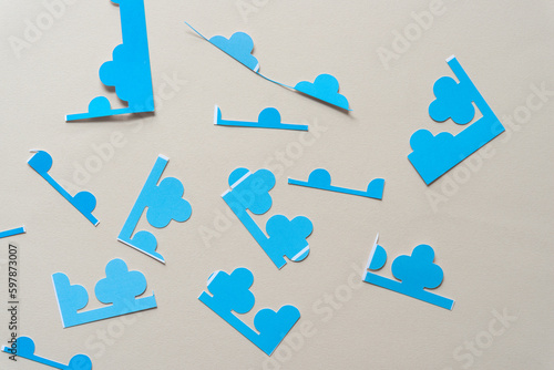 cut paper shapes with slight quatrefoil or trefoil shapes on blank paper