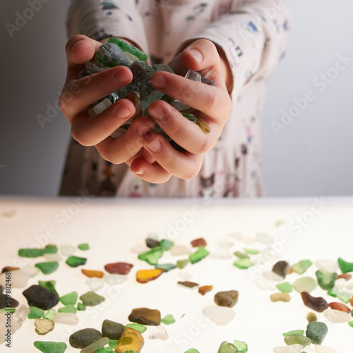 person holding brushed glass stones