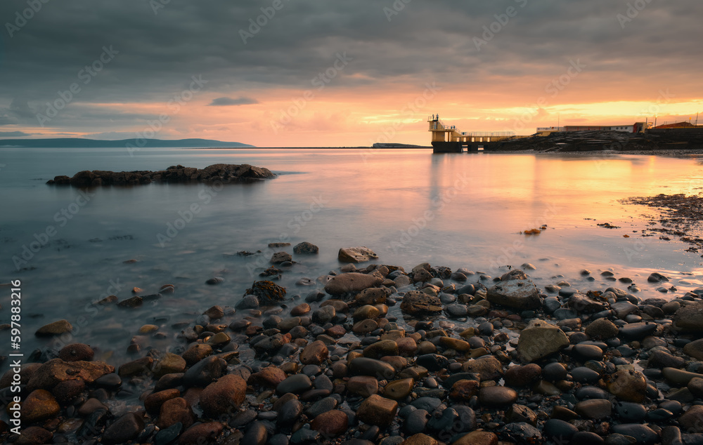 Dramatic coastal sunset landscape scenery with blackrock diving tower on Salthill beach, Galway, Ireland