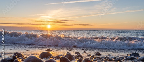 Fototapeta Naklejka Na Ścianę i Meble -  traumhafter, oranger, Sonnenuntergang zwischen Felsen im Meer der Ostsee bei Dranske auf Rügen	
