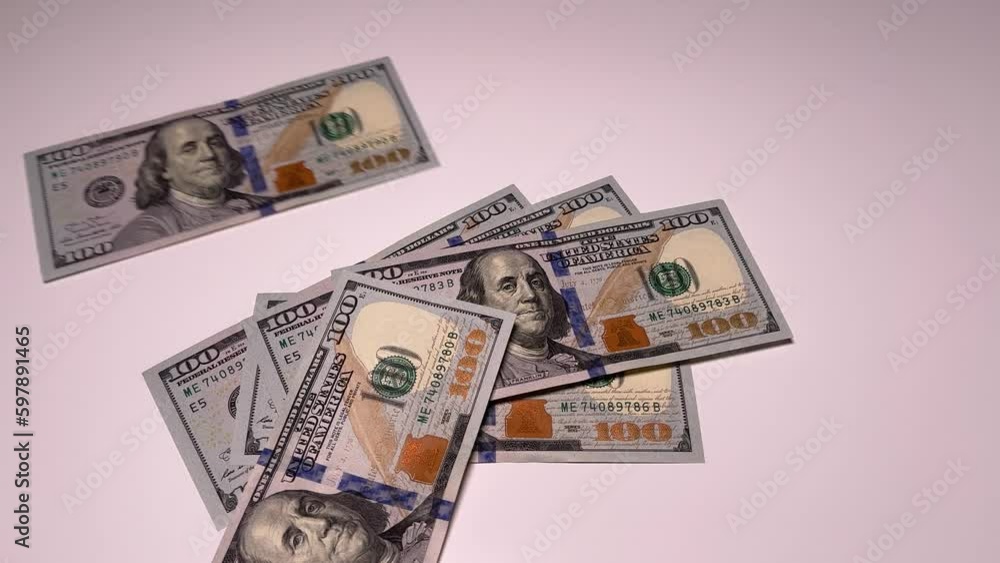 Dollars, banknotes falling on the table. Lots of 100 dollar bills Dollars, banknotes falling on the table. Lots of 100 dollar bills
