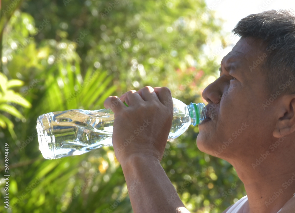 People drinking water. Man drinking water to cool down and quench your thirst. Focus on the arm