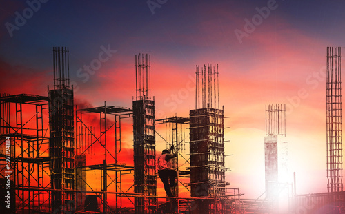 Silhouette engineer work on high ground heavy industry and safety concept over blurred natural background sunset pastel