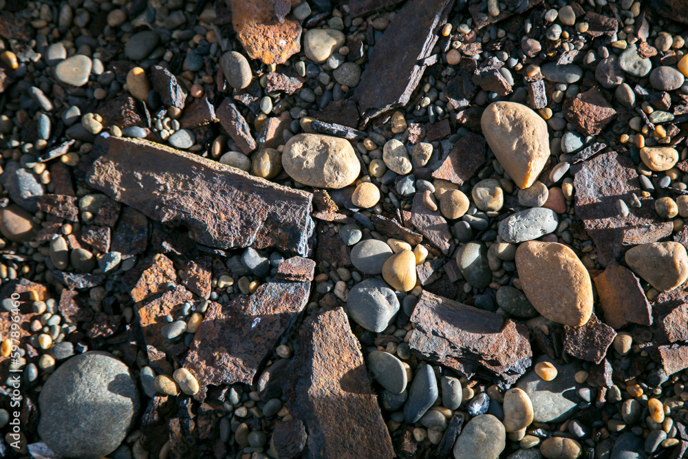 Texture or background of small stones at sunset Texture or background of small stones at sunset