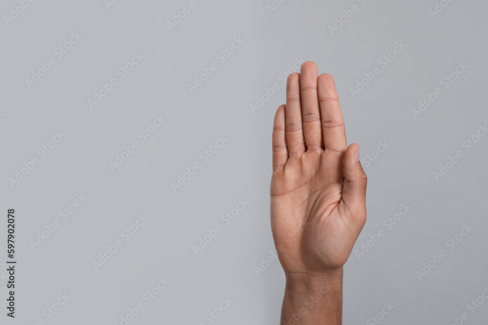 Man giving high five on grey background, closeup of hand. Space for text Man giving high five on grey background, closeup of hand. Space for text