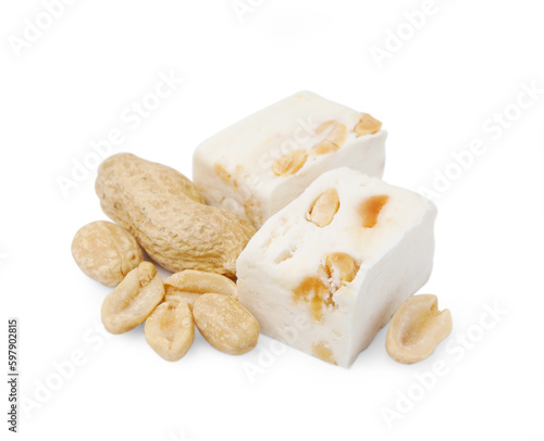 Pieces of delicious nougat and nuts on white background photo