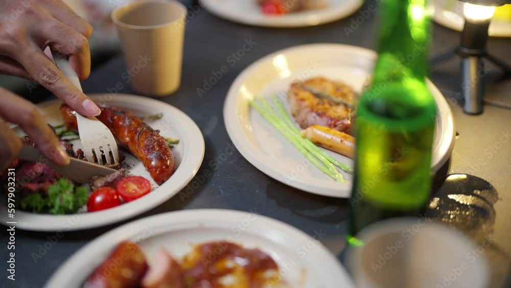 4K Group of Happy Asian people having dinner and talking together during camping in forest at night. Man and woman friends enjoy outdoor adventure lifestyle travel nature on summer holiday vacation. 4K Group of Happy Asian people having dinner and talking together during camping in forest at night. Man and woman friends enjoy outdoor adventure lifestyle travel nature on summer holiday vacation.