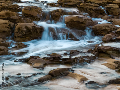 Sunrise and cascades over the rock platform