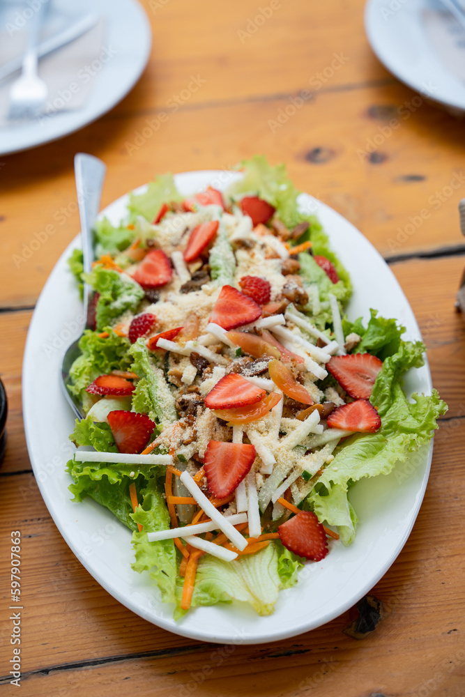 mixed strawberry salad in vinaigrette sauce consist of turnip, carrots, lettuce, bacon and strawberry mixed strawberry salad in vinaigrette sauce consist of turnip, carrots, lettuce, bacon and strawberry