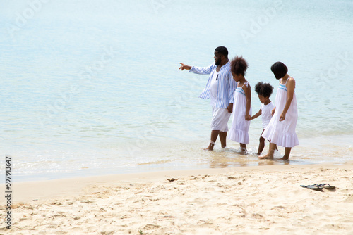Black family having fun on the beach. mixed race family relaxing at the beach on summer holiday