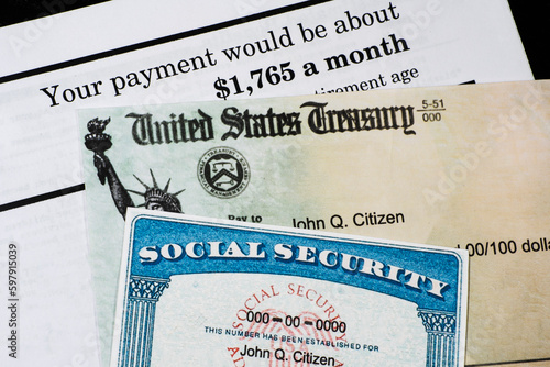 Corner of Social Security Administration annual statement with social secuiity check and ssn card. photo