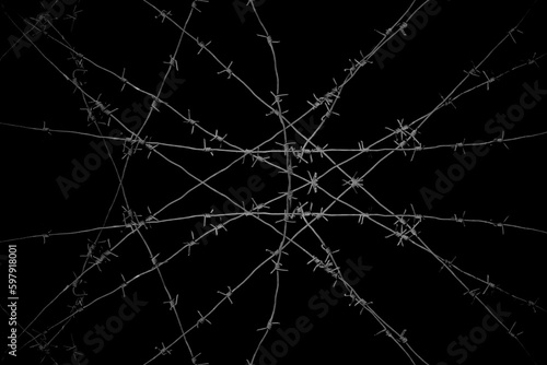 Old security barbed wire isolated on black background. Sharp military security fence. Closeup image. crossed Lines of barbed wire on black background. concentration camp