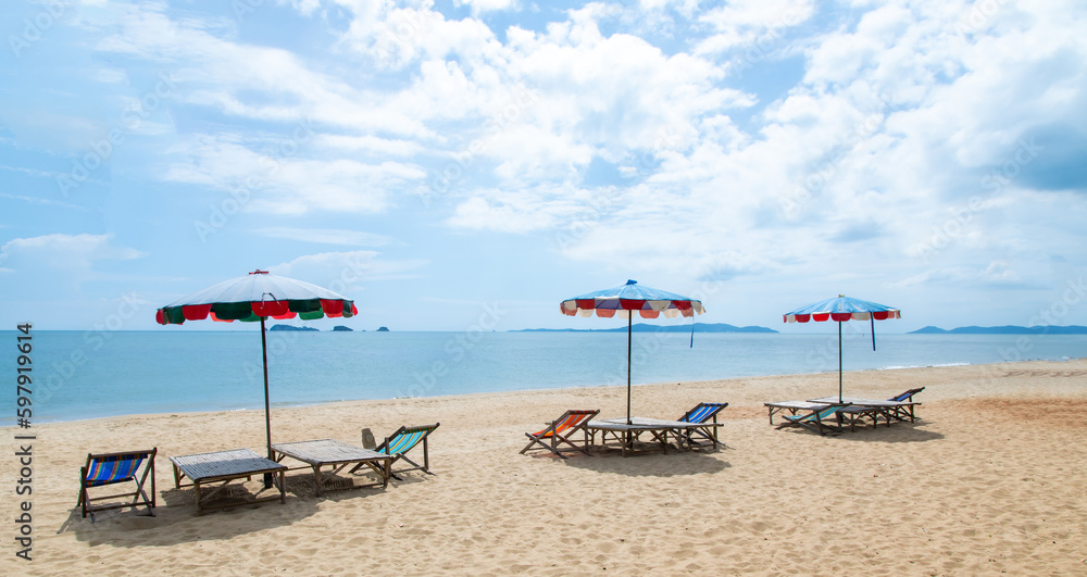 beach chairs on white sand beach on sea and blue sky. Chairs and umbrella. Tropical summer holiday beach chairs on white sand beach on sea and blue sky. Chairs and umbrella. Tropical summer holiday