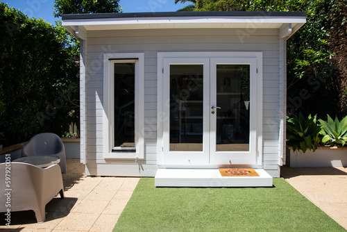 Modern hampton white grey backyard storage garden shed table chairs grass organise clever tidy tiny house 