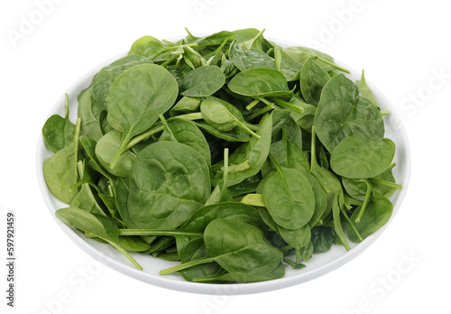 Bunch of fresh spring spinach leaves on a round plate
