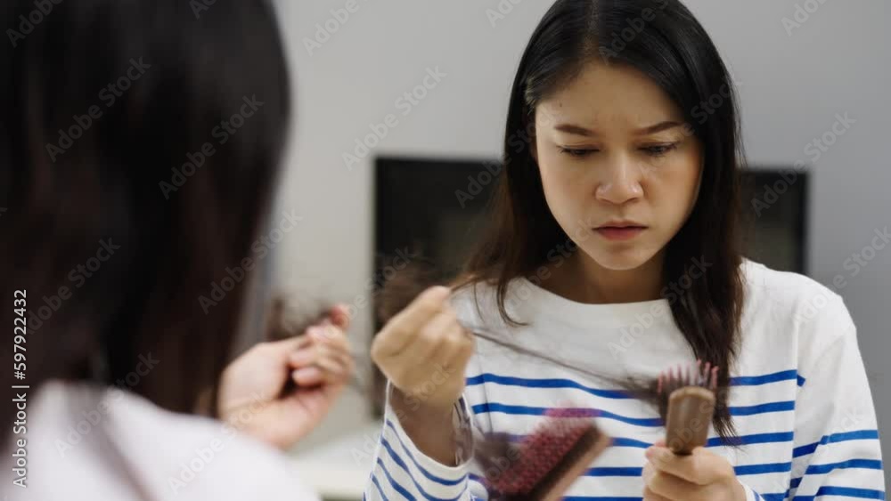 stressed woman suffering hair loss problem with her hairbrush in mirror at home stressed woman suffering hair loss problem with her hairbrush in mirror at home