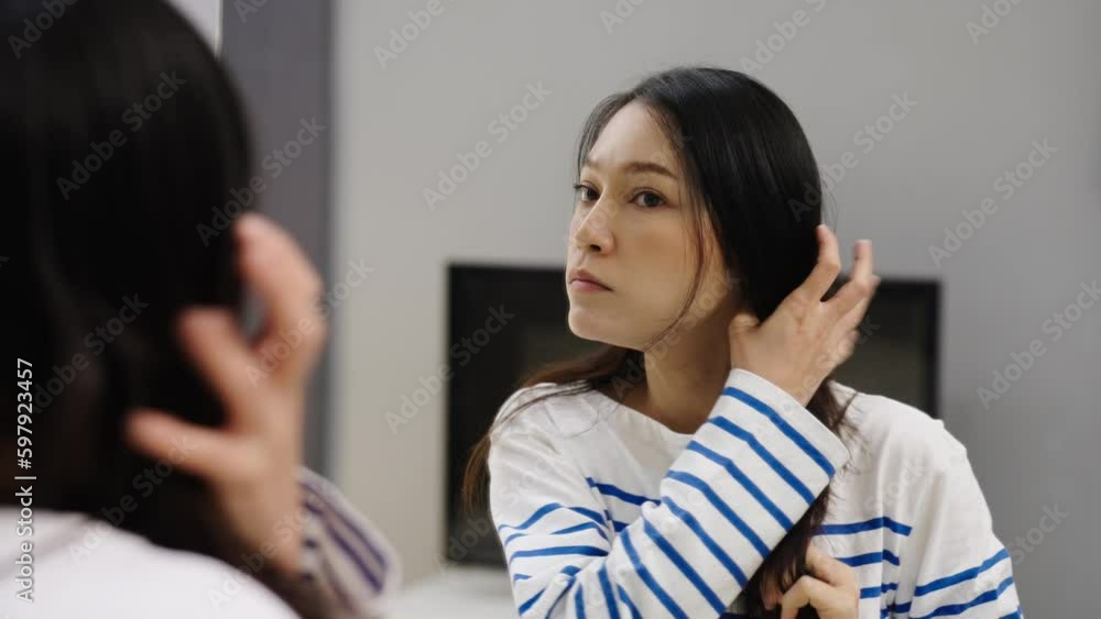 shocked woman suffering hair loss problem in mirror at home shocked woman suffering hair loss problem in mirror at home