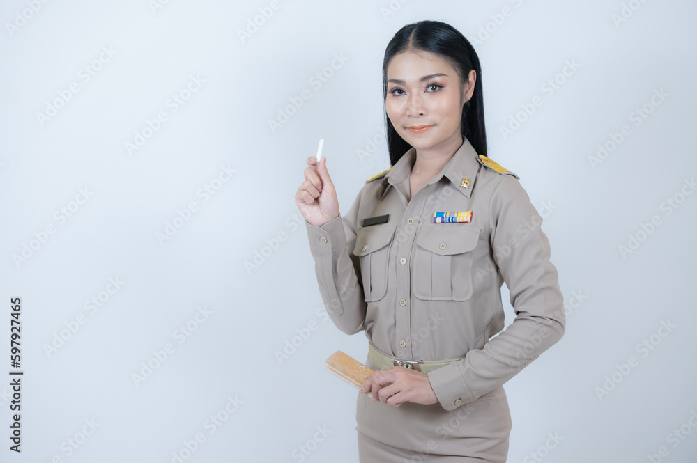 Thailand Teacher Uniform Brown, Young man wearing teacher uniform teaching in classroom, Education concept in Thailand. Thailand Teacher Uniform Brown, Young man wearing teacher uniform teaching in classroom, Education concept in Thailand.