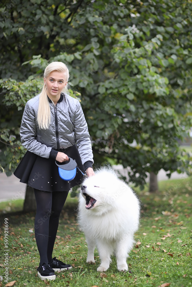Lovely girl on a walk with a beautiful dog