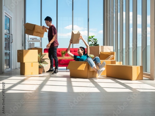 Asian cute girl carry box and ask to unpacking while young man busy manage many cardboard in the new condominium after relocated