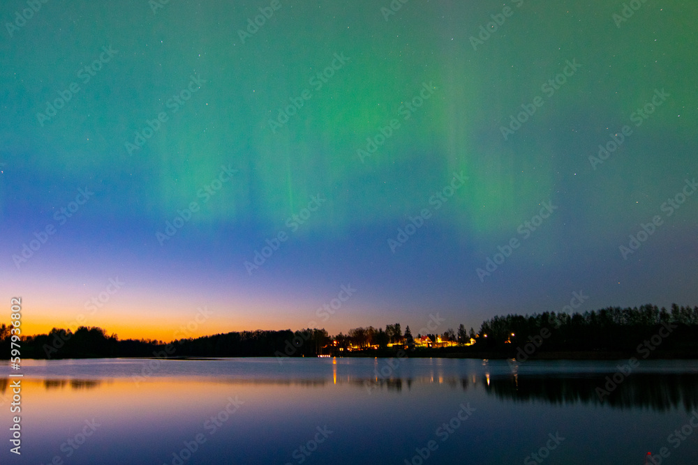 northern lights and its reflection the lake, northern lights shimmer over the lake, northern lights in spring, Lielais Ansis, Rubene, Latvia