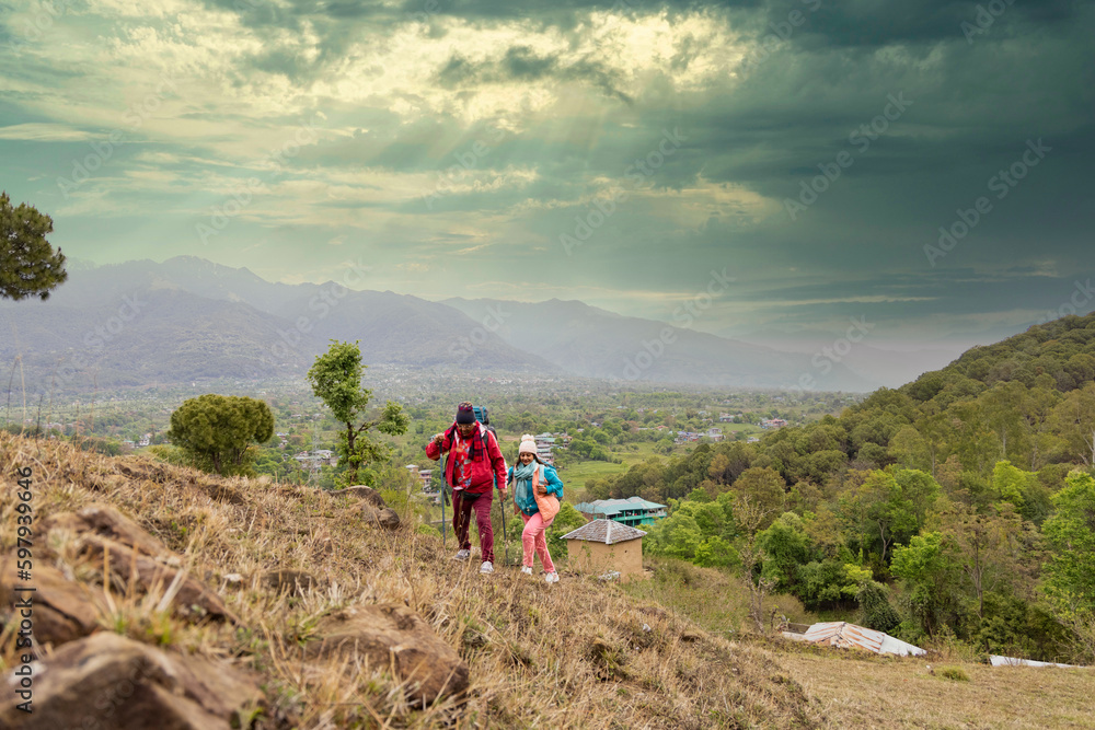 Obraz premium Happy couple trekking on a mountain.