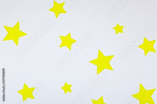 Yellow felt stars of different sizes on a white background. isolate