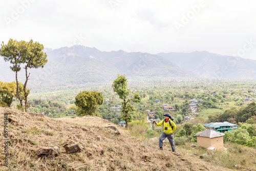 Happy senior man hiking in spring day on a hill.