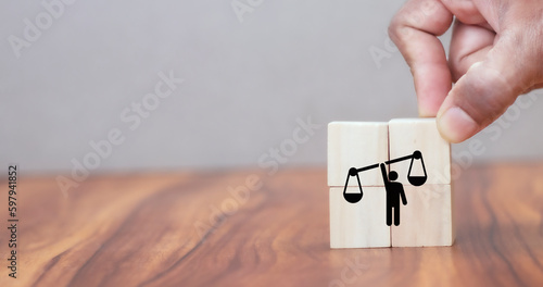 Business ethics concept. Business moral principles concept. Hand holds the wooden cubes with "ETHICS" symbols on grey background and copy space. Banner for business integrity, good governance policy c