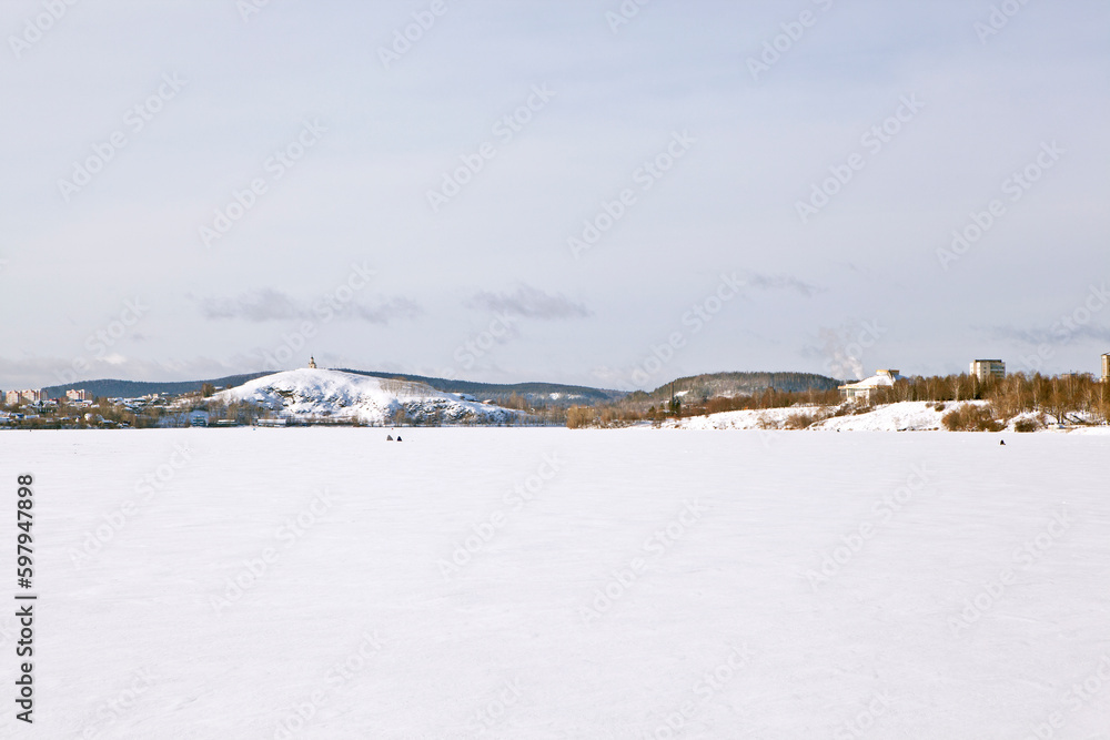 Landscape of the Nizhny Tagil winter pond with a view of Lisya Mountain and Vysokaya Mountain. Nizhny Tagil. Sverdlovsk region. Russia