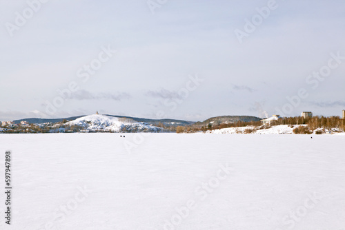 Landscape of the Nizhny Tagil winter pond with a view of Lisya Mountain and Vysokaya Mountain. Nizhny Tagil. Sverdlovsk region. Russia