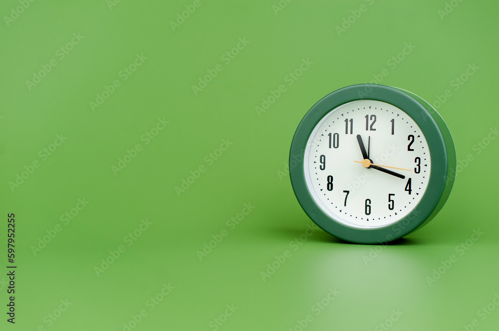clock precious time alarm clock on green background concept of time working with time clock precious time alarm clock on green background concept of time working with time