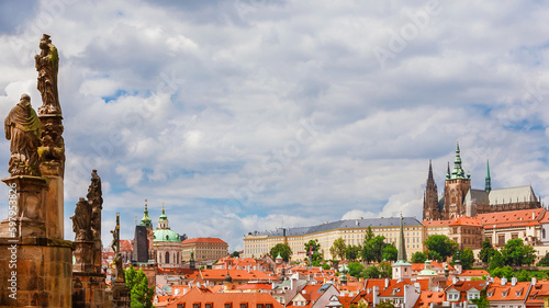 View of Prague historical center Mala Strana old district with gothic St. Vitus Cathedral at the top and Charles Bridge baroque statues photo