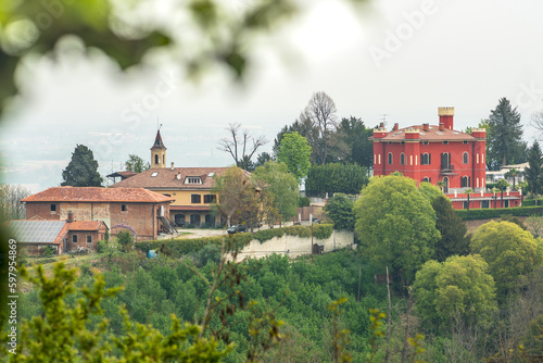Panoramic view of the hills with green vegetation and a red castle or building from San Sebastiano da Po Castle, Torino, Piemonte region, Italy
