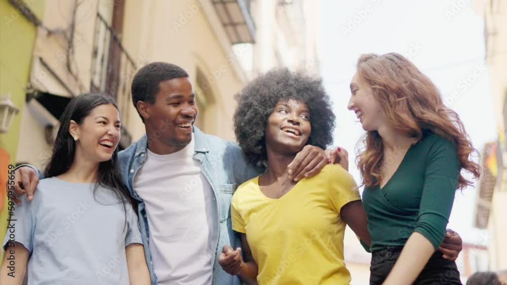 Happy group of multiethnic friends standing together along the street Happy group of multiethnic friends standing together along the street