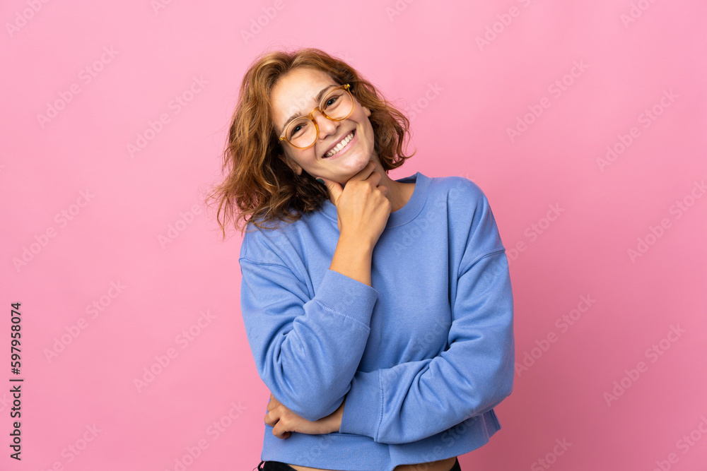 Young Georgian woman isolated on pink background with glasses and smiling Young Georgian woman isolated on pink background with glasses and smiling
