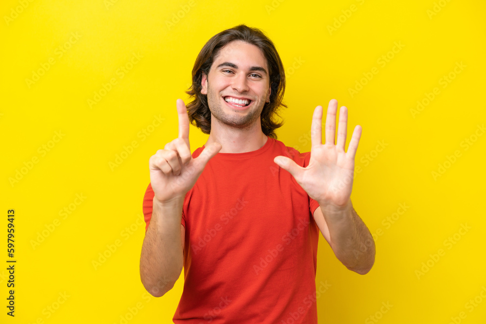 Caucasian handsome man isolated on yellow background counting seven with fingers Caucasian handsome man isolated on yellow background counting seven with fingers