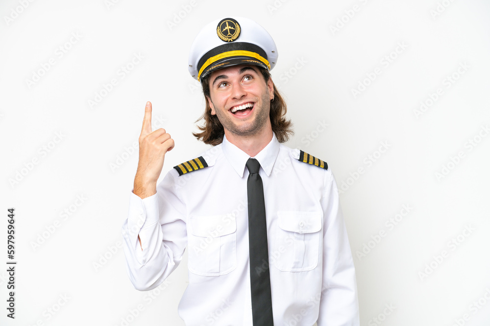 handsome Airplane pilot isolated on white background pointing up and surprised handsome Airplane pilot isolated on white background pointing up and surprised