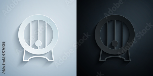 Paper cut Wooden barrel on rack with stopcock icon isolated on grey and black background. Paper art style. Vector