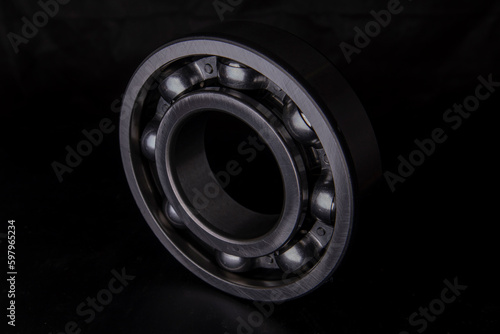 A large bearing in a hand on a dark background