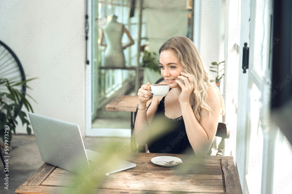 freeland working girl Sitting in a cafe at a wooden table drinking coffee and using the smartphone on the table as a laptop. Young woman surfing the internet, chatting, blogging. freeland working girl Sitting in a cafe at a wooden table drinking coffee and using the smartphone on the table as a laptop. Young woman surfing the internet, chatting, blogging.