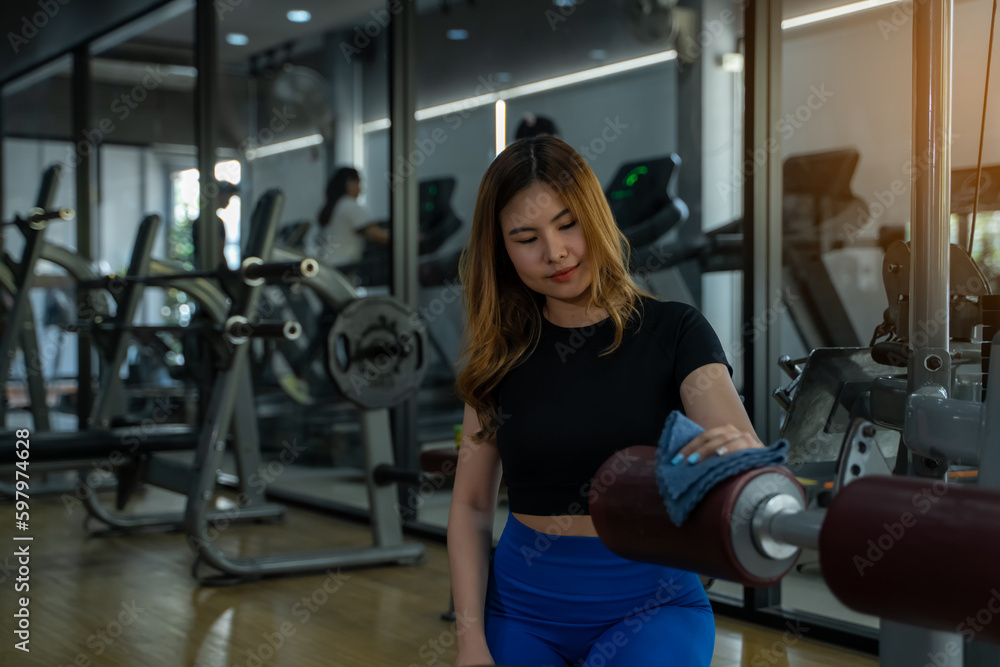 girl in sportswear Checking and cleaning equipment in gym, fitness, sport, workout concept girl in sportswear Checking and cleaning equipment in gym, fitness, sport, workout concept