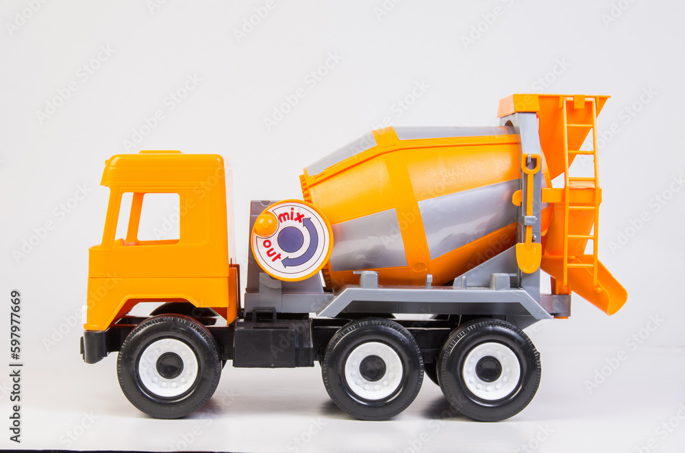 Concrete truck. Multi-colored children's toys plastic trucks on a white background.