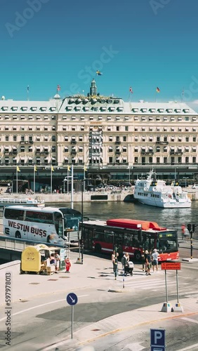 Stockholm, Sweden. Vertical Footage Video Traffic With Cars And Buses. Grand Hotel Located On Peninsula Blasieholmen. Touristic Pleasure Boats Floating Near Famous Grand Hotel In Sunny Generative AI photo