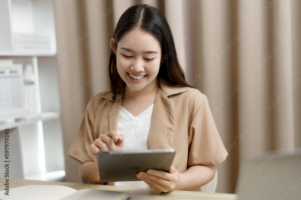 Happy Confident young asian businesswoman working with tablet Start up small business owner. business successful technology concept Happy Confident young asian businesswoman working with tablet Start up small business owner. business successful technology concept