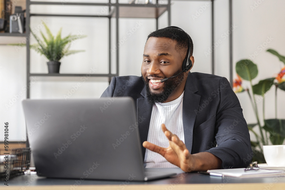 Male working remotely. Online interview between African American business man hr director and job candidate. Recruitment manager talking using laptop, hiring for job person sitting in office Male working remotely. Online interview between African American business man hr director and job candidate. Recruitment manager talking using laptop, hiring for job person sitting in office
