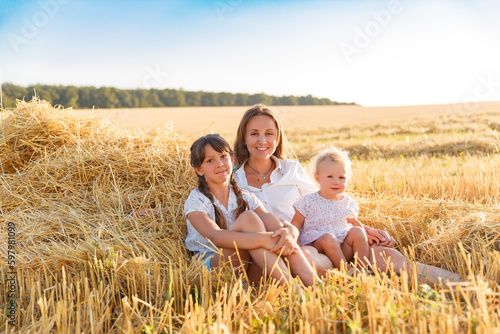 girls in a wheat field at sunset. Ukraine . Family walk in the field, wheat field, sunset in the field, girl in vyshyvanka in the field