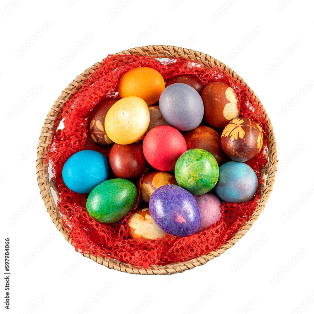 Fototapeta premium Top view of multicolored Easter eggs in a basket at white background. Pastel colored Easter eggs.