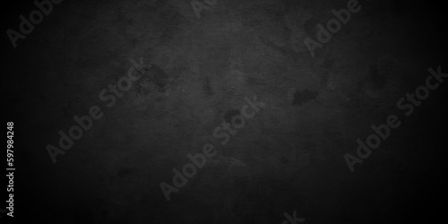 Dark black Close up retro plain dark black cement and concrete wall background texture. Background image of texture plaster on the wall in dark black tones in grunge style backdrop.